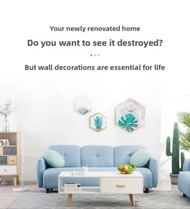 Modern living room featuring a light blue fabric sofa, white coffee table, and wall decor