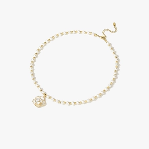 Elegant pearl choker necklace with a white camellia flower pendant and golden metallic beads