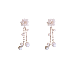 Boucles d'oreilles à fleurs avec longs glands en perles et perles de cristal sur fond blanc
