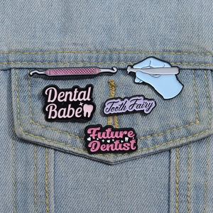 Dental theme enamel pin set featuring tooth fairy designs on blue denim background