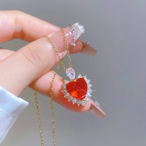 Elegant gold titanium steel necklace featuring a red heart zircon pendant and halo crystals