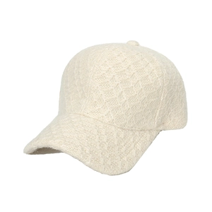 Creamy white cable knit baseball cap for women with warm textured winter fabric