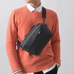 Men's black water-resistant nylon crossbody chest bag with sports label and metal zippers
