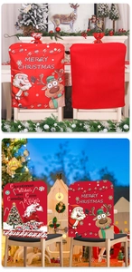 Close-up of festive red Christmas chair covers with Santa and reindeer cartoon designs