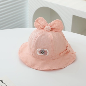 Detailed view of pink waffle fabric texture and bunny patch on baby sun bucket hat