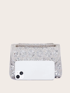 Silver rhinestone evening clutch with chain strap shown next to a smartphone for size reference
