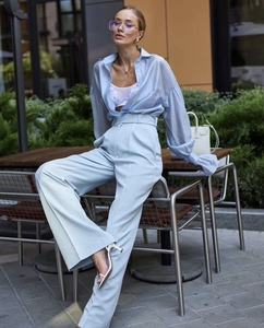 Light blue oversized shirt and wide-leg trousers set shown in a stylish outdoor setting