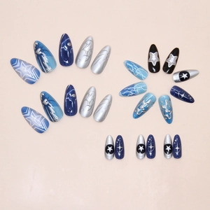 Detailed flat lay of blue cat eye press on nails with silver stars and lightning patterns