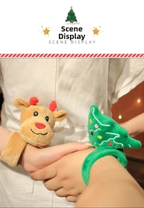 Detail view of plush Christmas reindeer and tree snap bracelets on a child's wrist