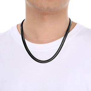 Macro view of black snake bone chain necklace with metallic finish on a model