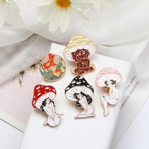 Set of five creative mushroom girl enamel pins in various colors on a white display