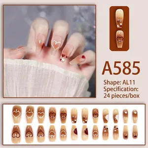 Detail view of A585 almond press-on nails featuring brown gradient and heart patterns