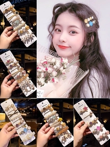 Detail view of pearl and crystal hair clip sets with diverse geometric floral patterns