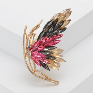 Exquisite butterfly brooch with colorful crystals and golden frame on a white stand