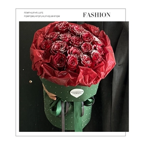 Elegant red roses bouquet in phantom series diamond wrapping paper held by model