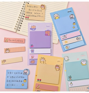 Detailed view of cute cartoon animal sticky notes and index tabs on a pink desk