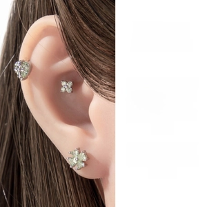 Silver cartilage studs with mint green zircon in heart and flower shape on ear model