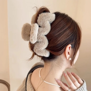 Eleganter khakifarbener Plüsch-Haarclip für Damen, getragen von einem Modell von hinten