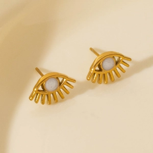 Exaggerated golden eye stud earrings with white round stone and eyelash design