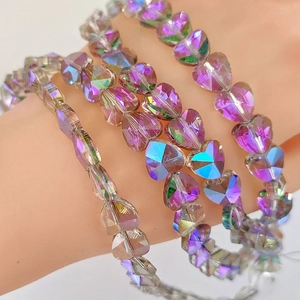 Macro shot of faceted AB purple crystal heart beads with sparkling iridescent finish