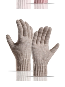 Detail of oatmeal knit gloves with ribbed cuffs and soft thermal texture for winter