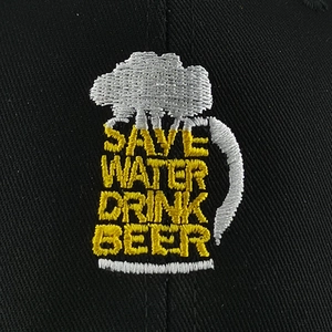 Detailed macro view of high-quality embroidery with 'Save Water Drink Beer' text on a cap