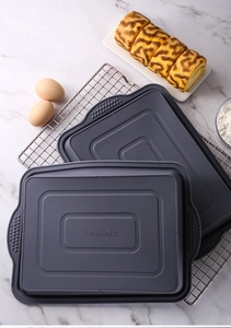 Detail of grey rectangular silicone brownie baking pans with handles on a marble surface