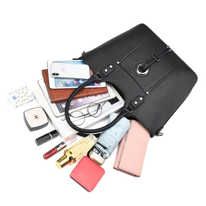 Large black leather tote bag showing spacious interior for daily items and accessories