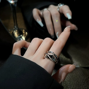 Close-up of minimalist silver geometric ring with black zircon on model finger