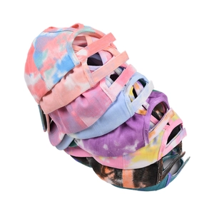 Detailed view of colorful tie-dye baseball caps with criss-cross ponytail hole design