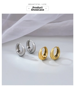 Detailed view of chunky water drop hoop earrings in polished gold and silver finishes