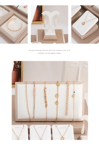 Detailed display of gold necklaces and bracelets set with zircon and pearl accents