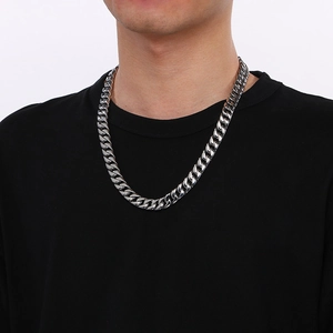 Polished silver stainless steel 12mm Cuban link chain necklace worn by male model