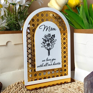 Detail of white and gold acrylic Mother's Day plaque with Mom script and floral design