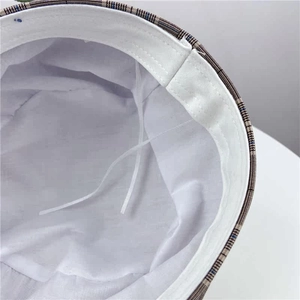 Detail of plaid beret with adjustable white inner lining and drawstring for custom fit