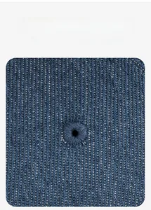 Macro detail of blue denim texture and embroidered eyelet on the vintage docker hat
