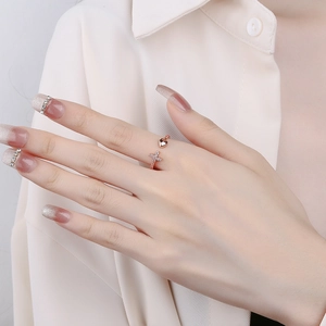 Rose gold adjustable ring featuring a polished heart and diamond-encrusted cross