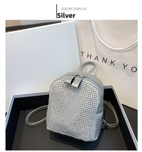 Detail of silver mini backpack with rhinestone embellishments and double zip closure