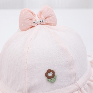 Pink infant sun hat with large polka dot bow, floral embroidery and textured fabric