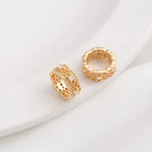 Detail view of 14K gold plated hollow lace beads with cubic zirconia for jewelry making