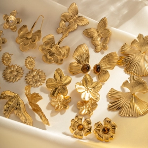 Tiger eye stone titanium steel butterfly earrings with 18k gold plating on silk background