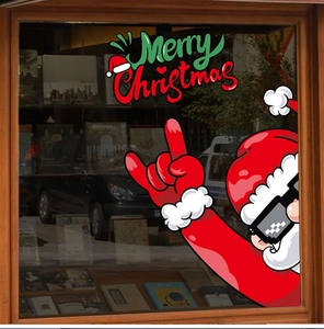 Detail of Santa Claus static window sticker with Merry Christmas text on glass storefront