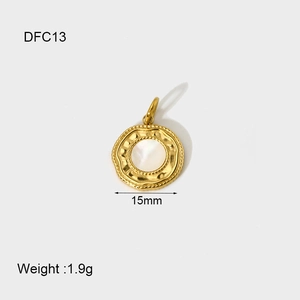 Detail of 14K gold plated shell pendant with white mother of pearl inlay, 15mm diameter