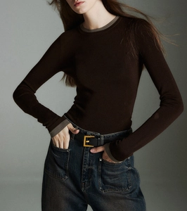 Detailed view of dark brown wool knit top featuring grey contrast trim on collar and cuffs