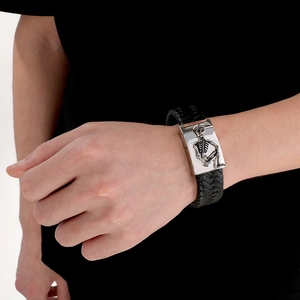 Men's vintage braided leather bracelet with silver skull charm and magnetic metal clasp