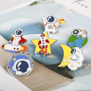 Detailed macro view of 6 cute astronaut enamel pins featuring space and rocket themes