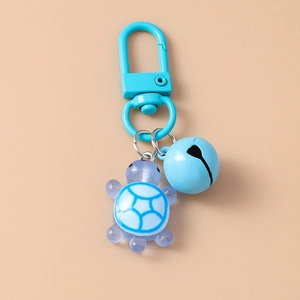 Detail of blue resin turtle keychain with matching bell and metallic spring hook