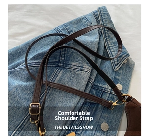 Detail of adjustable dark brown leather shoulder strap with gold metal buckle and clasp