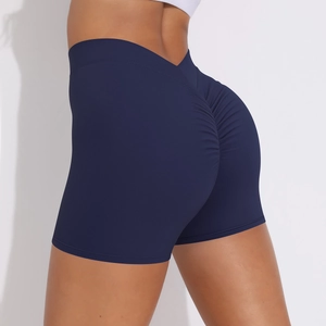 Detail showing high-waisted navy blue yoga shorts with V-cut waistband and scrunch butt design
