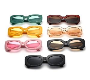 Flat lay of retro rectangle sunglasses in vibrant candy colors on white background